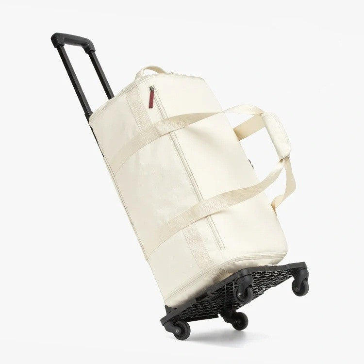 Cream RoamiBag wheeled duffel with pull handle, shown from the side on a white background